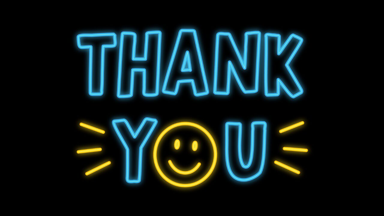 Neon sign displaying the words "thank you" with a smiling face. Neon sign displaying the words "thank you" with a smiling face.